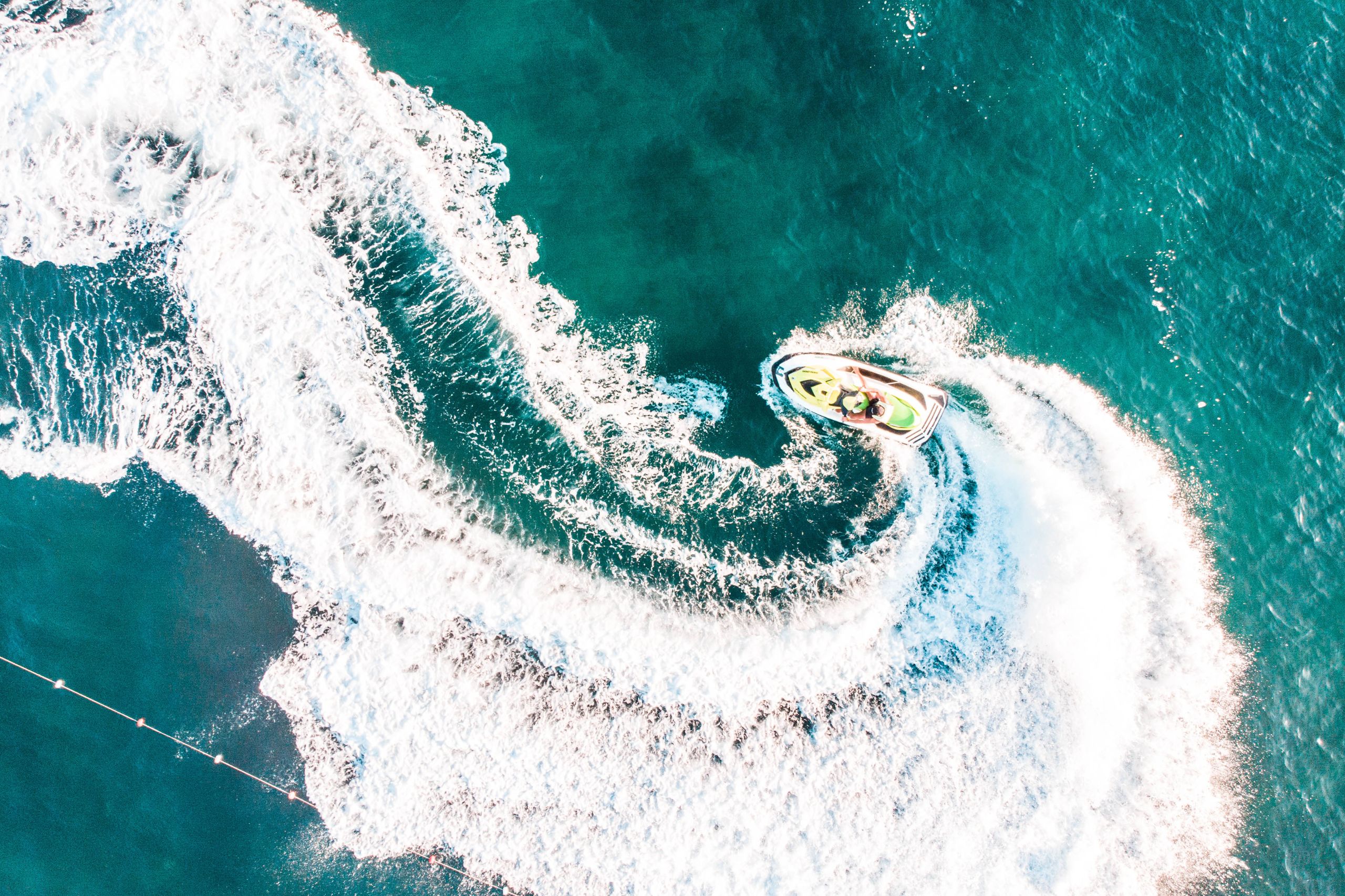 Aerial view of a jet ski making waves